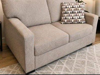 Cozy Brown Loveseat with Patterned Throw Pillow