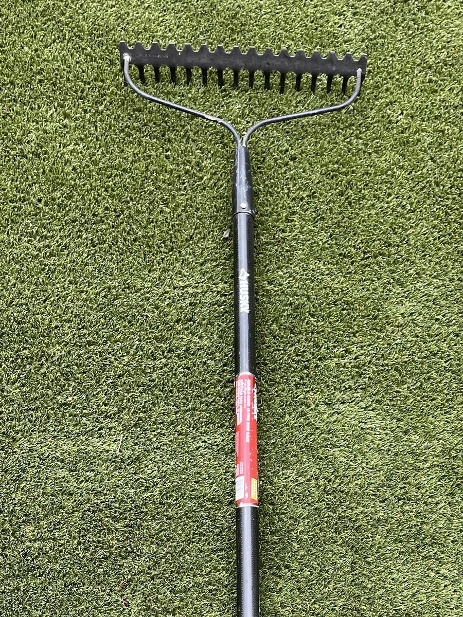 Landscaping/Garden tool: double sided rake with fiberglass handle.