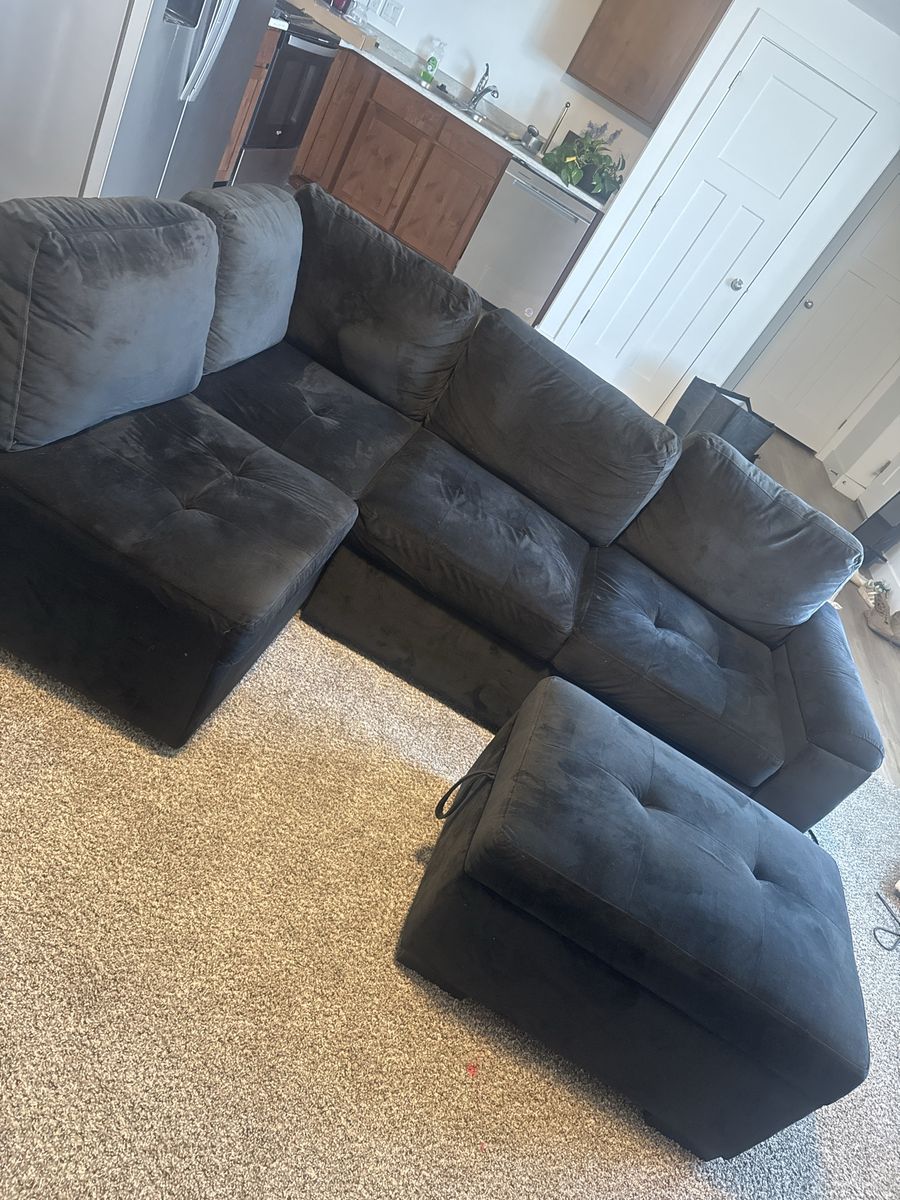 Black Sectional Couch with Ottoman and Built-in USB/Power Outlets - Good Condition, also has a pull out sleeper
