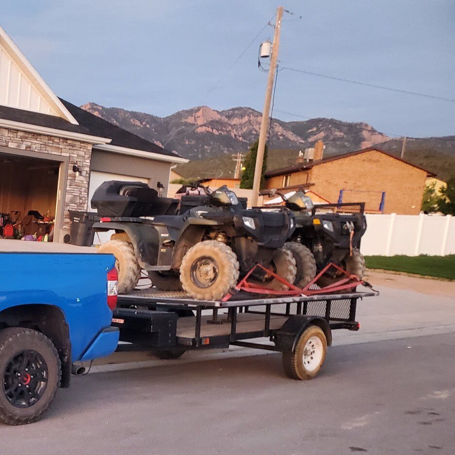 Two polaris sportsman 500 with trailer