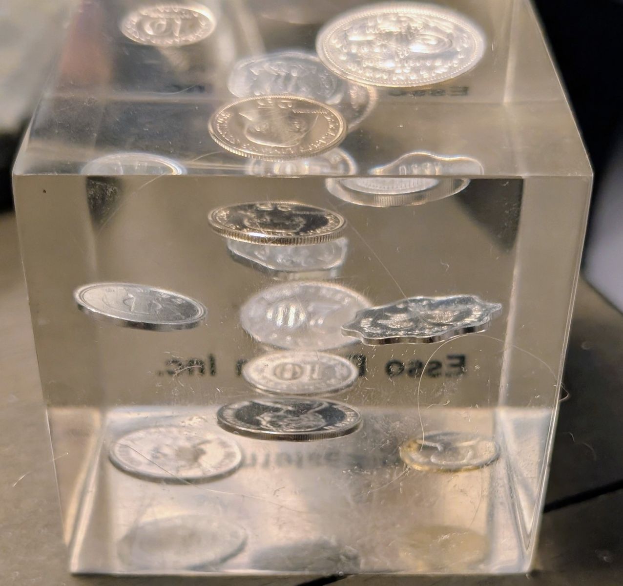 This vintage 1960s or 1970s Lucite paperweight features encased Canadian coins