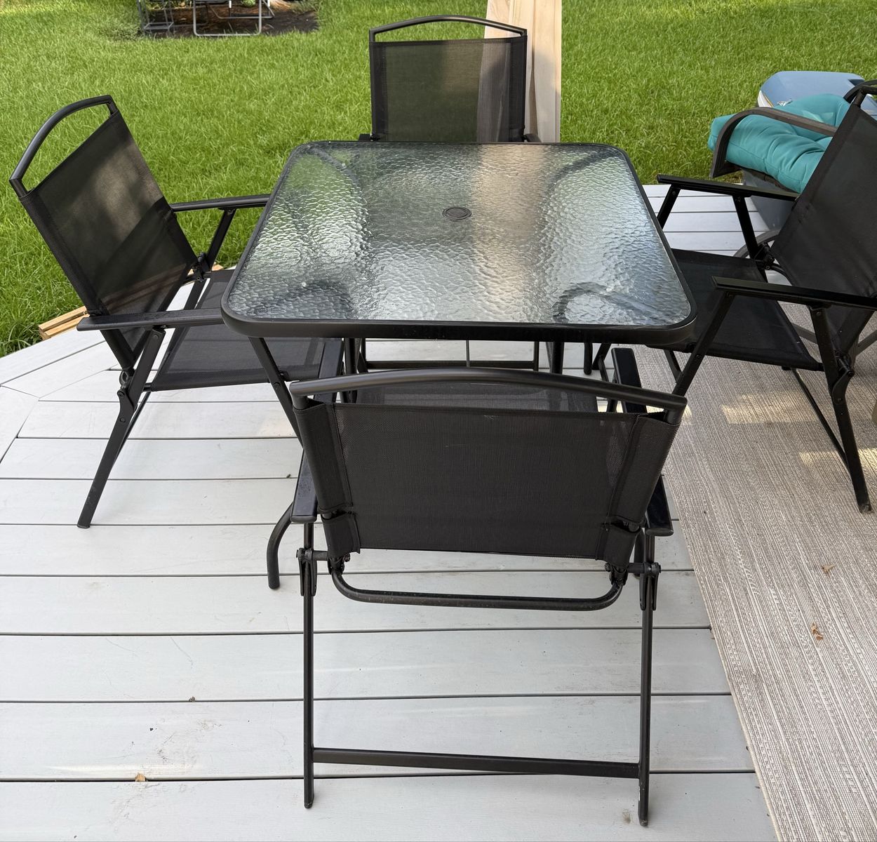 Black Metal Patio Set with Square Glass Table and Four Folding Chairs
