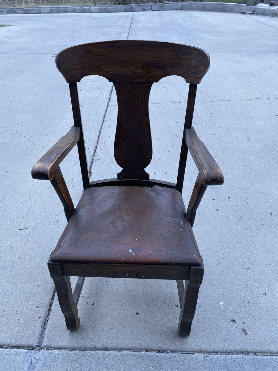 Antique captain chair from dining room set.