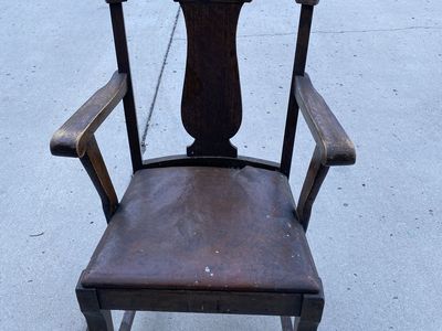 Antique captain chair from dining room set.
