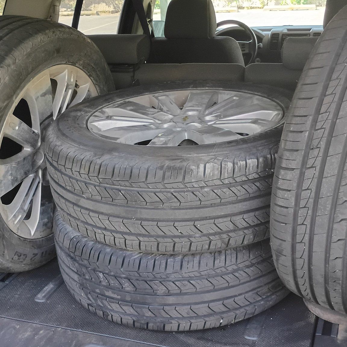 Four tires with rims and lug nuts  235 / 55 R18