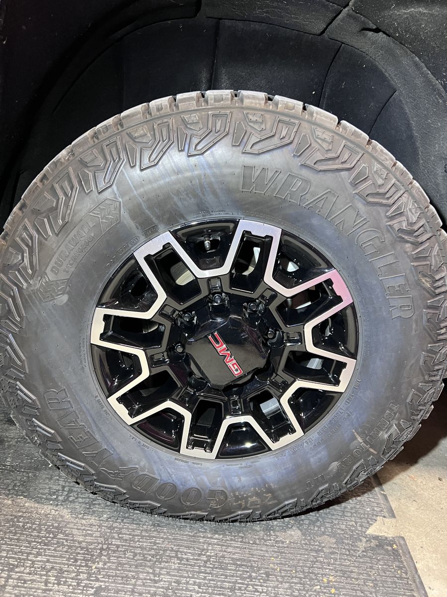 Goodyear wrangler territory MT. LT305-70-18. Mounted on GMC rims 8x180.  Set of four.