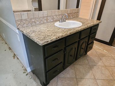 Black Vanity with Granite Countertop and Oval Sink