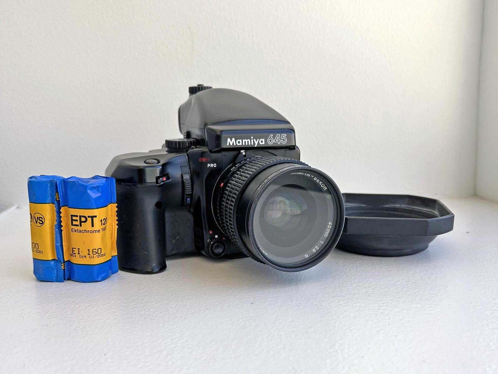 Mamiya 645 Pro Medium Format Film Camera with Mamiya-Sekor 45mm f/2.8 Lens, Hood, and 2 120 Film back canisters.