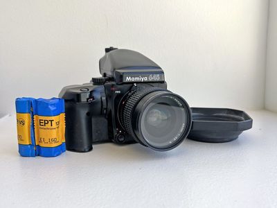 Mamiya 645 Pro Medium Format Film Camera with Mamiya-Sekor 45mm f/2.8 Lens, Hood, and 2 120 Film back canisters.