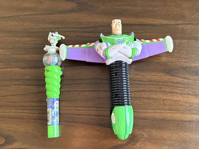 Vintage Disney Pixar Toy Story Buzz Lightyear Spinning Spaceship Toy, and a small Buzz light year Candy Wand Toy Lot