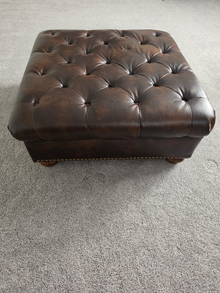 Brown Tufted Faux Leather Ottoman with Nailhead Trim