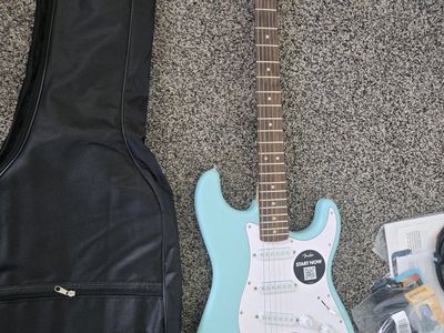 Squier by Fender Stratocaster Electric Guitar Bundle with Amp, Gig Bag, and Accessories