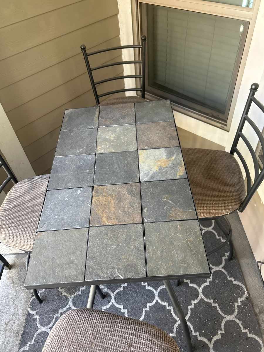 Iron bar table and chairs with stone top