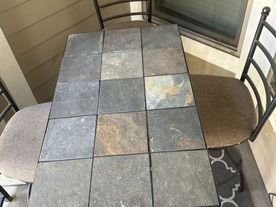 Iron bar table and chairs with stone top