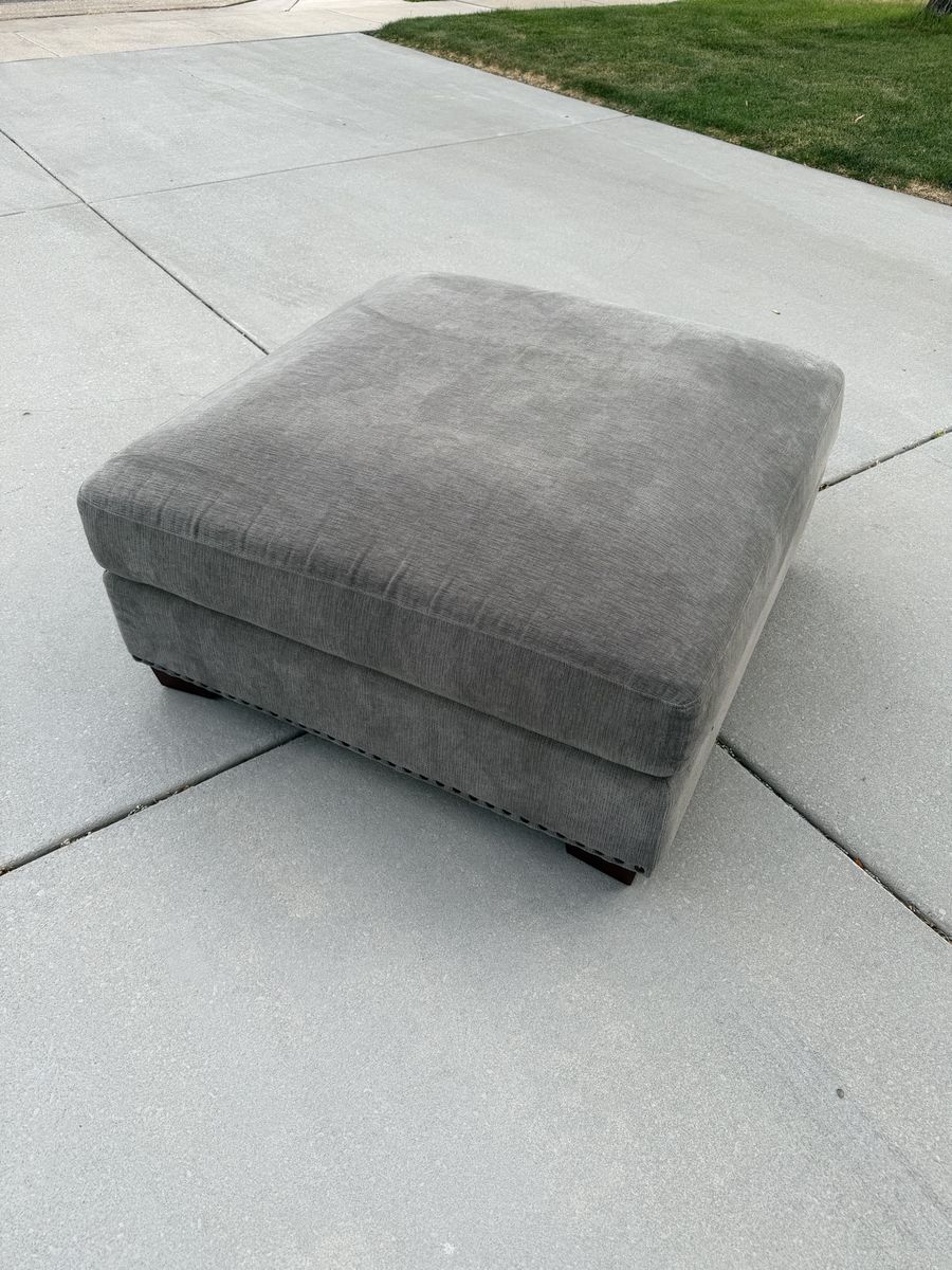 Gray Upholstered Ottoman with Nailhead Trim