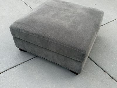 Gray Upholstered Ottoman with Nailhead Trim