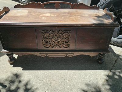 Vintage Wooden Storage Chest with Ornate Carved Front and Bun Feet