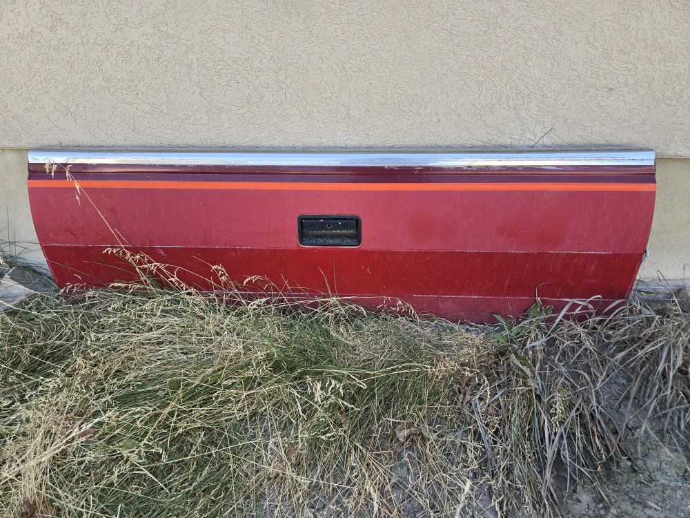 Red Pickup Truck Tailgate with Chrome Trim Accent