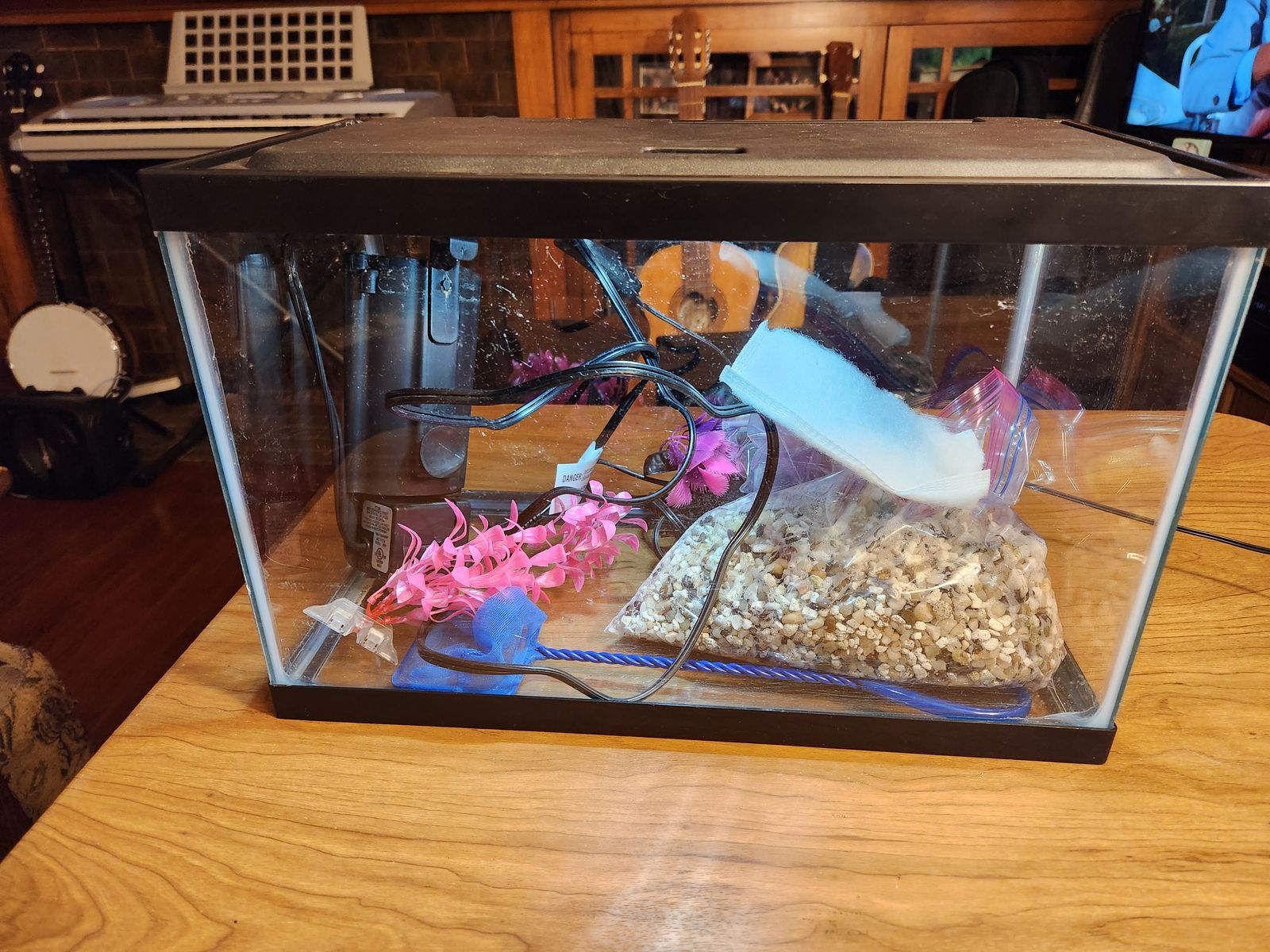 5 gallon fish tank, nice led light hood, filter with two pads, heater, gravel, net, and a couple of plastic plants.