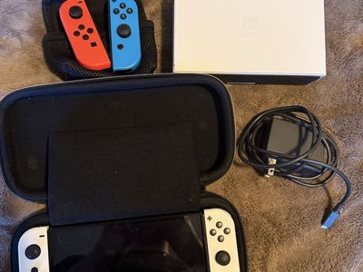 Nintendo switch OLED with case, charger, and extra joycons