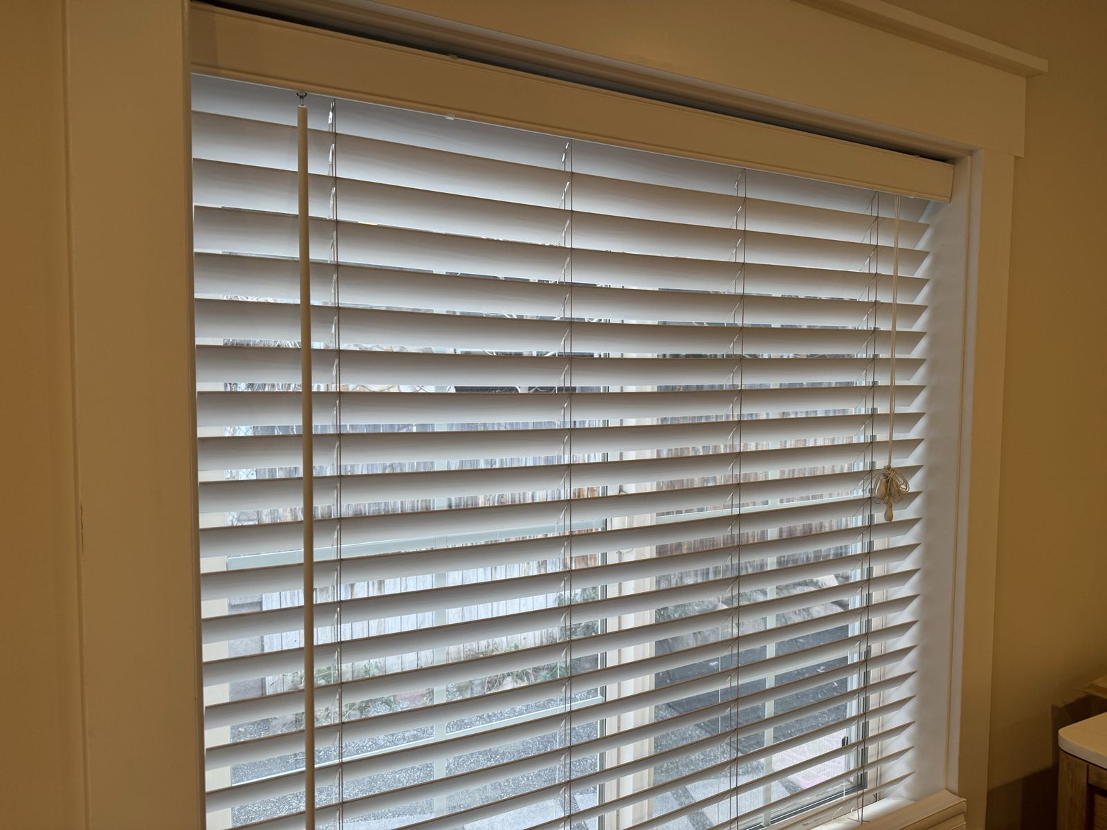 Three sets of white window blinds