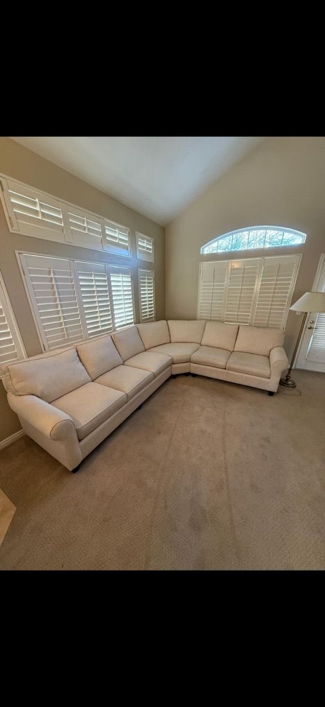 Cream colored comfort roll arm sofa