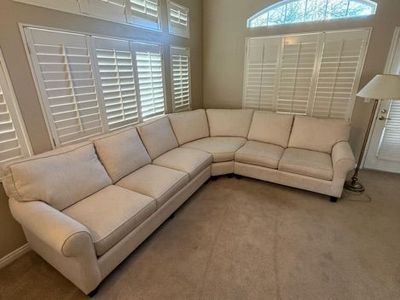 Cream colored comfort roll arm sofa