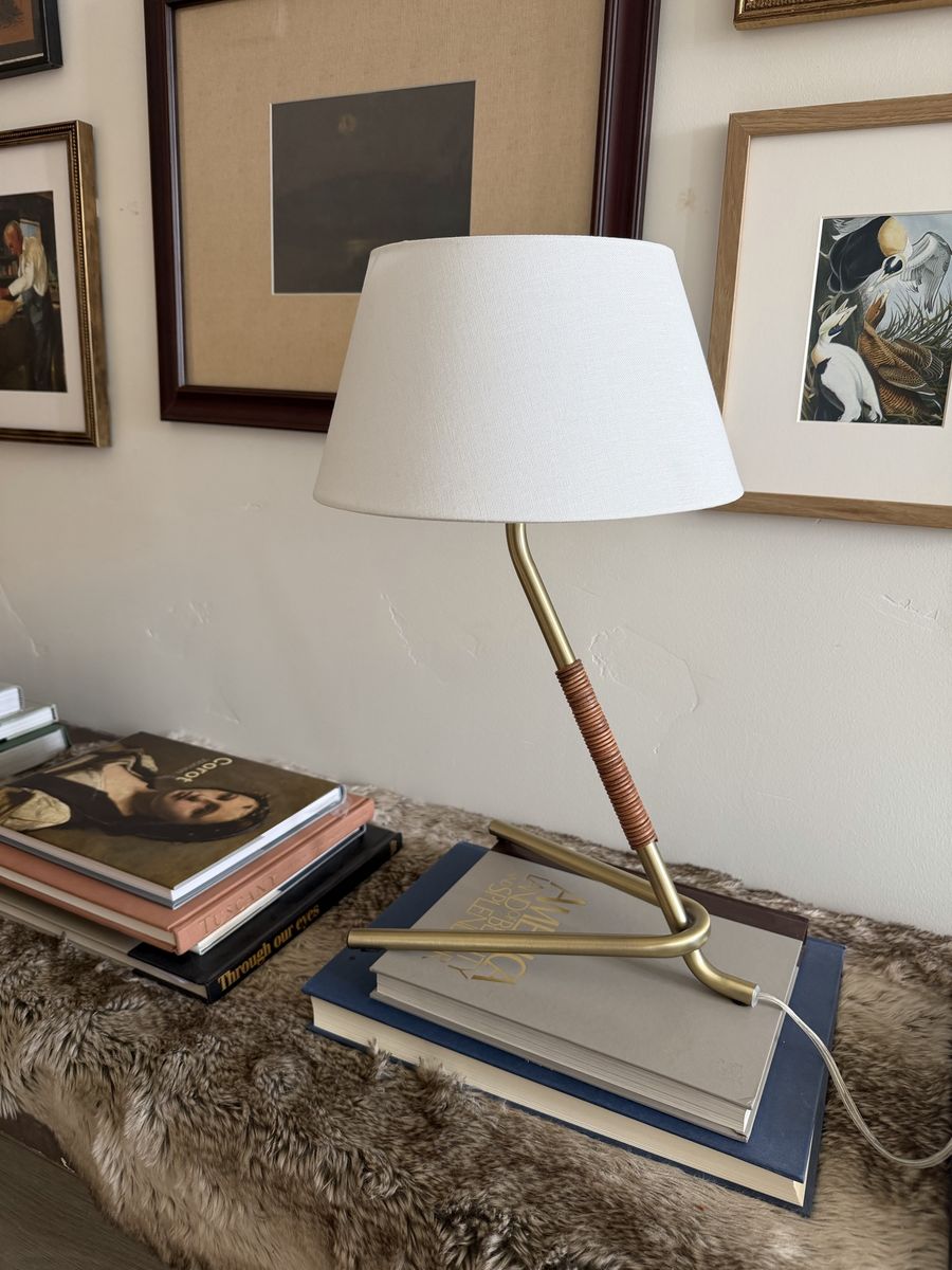 Brass table lamp with tripod base and leather wrapped neck 