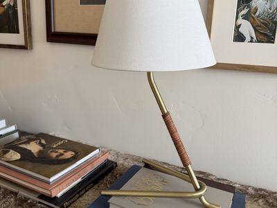 Brass table lamp with tripod base and leather wrapped neck