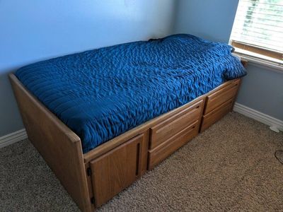 Wood twin bed with drawers.