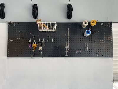 Used Black Pegboard Wall Organizer with Assorted Hooks & Basket - 2 Piece Set