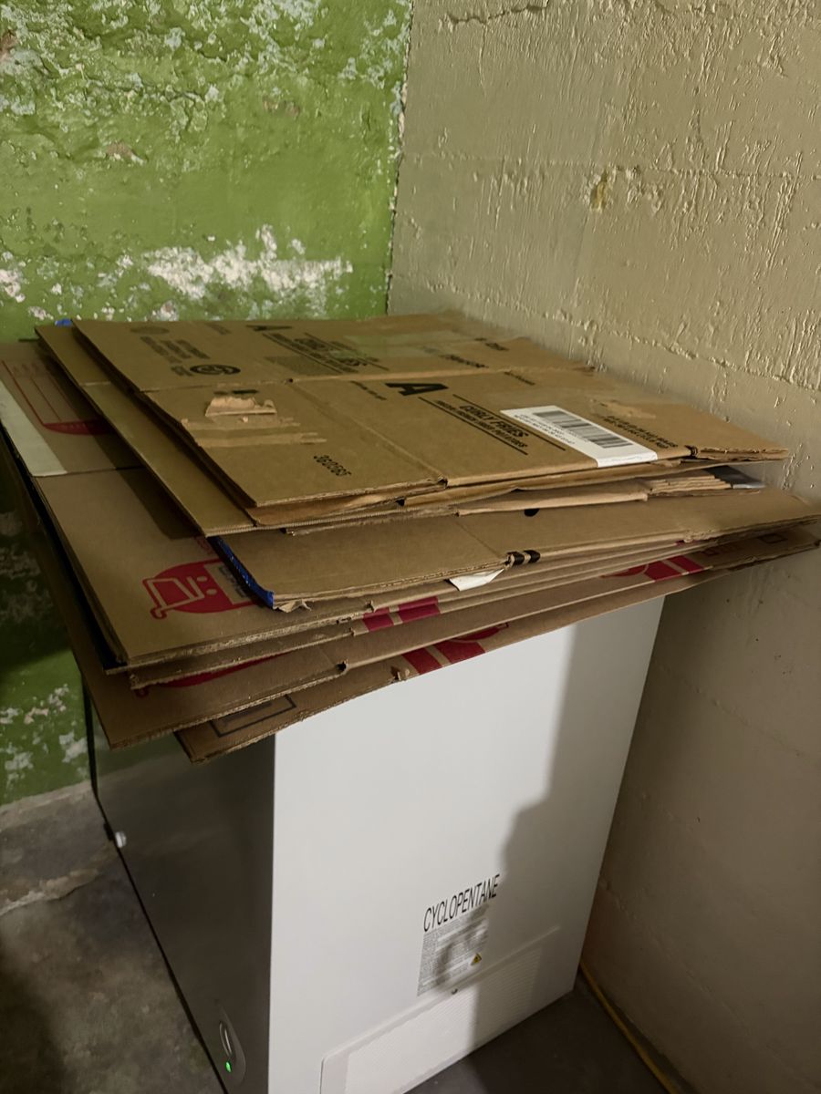 Assorted Cardboard Moving Boxes Stacked Flat