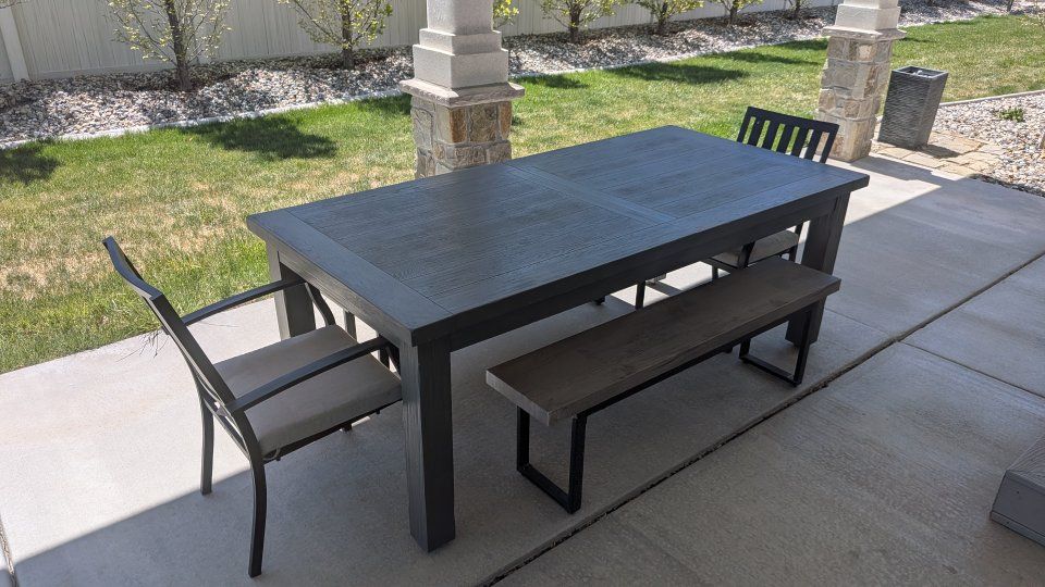 Indoor/outdoor dining table with expandable leaf.