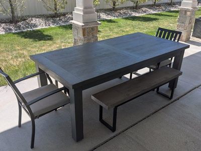Indoor/outdoor dining table with expandable leaf.