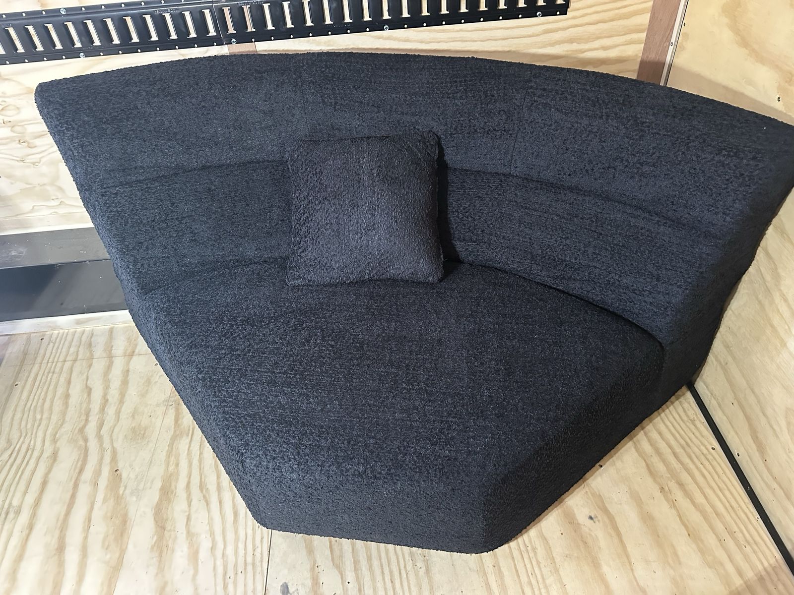 “Boneless” Black Textured Curved Corner Sofa with Accent Pillow
