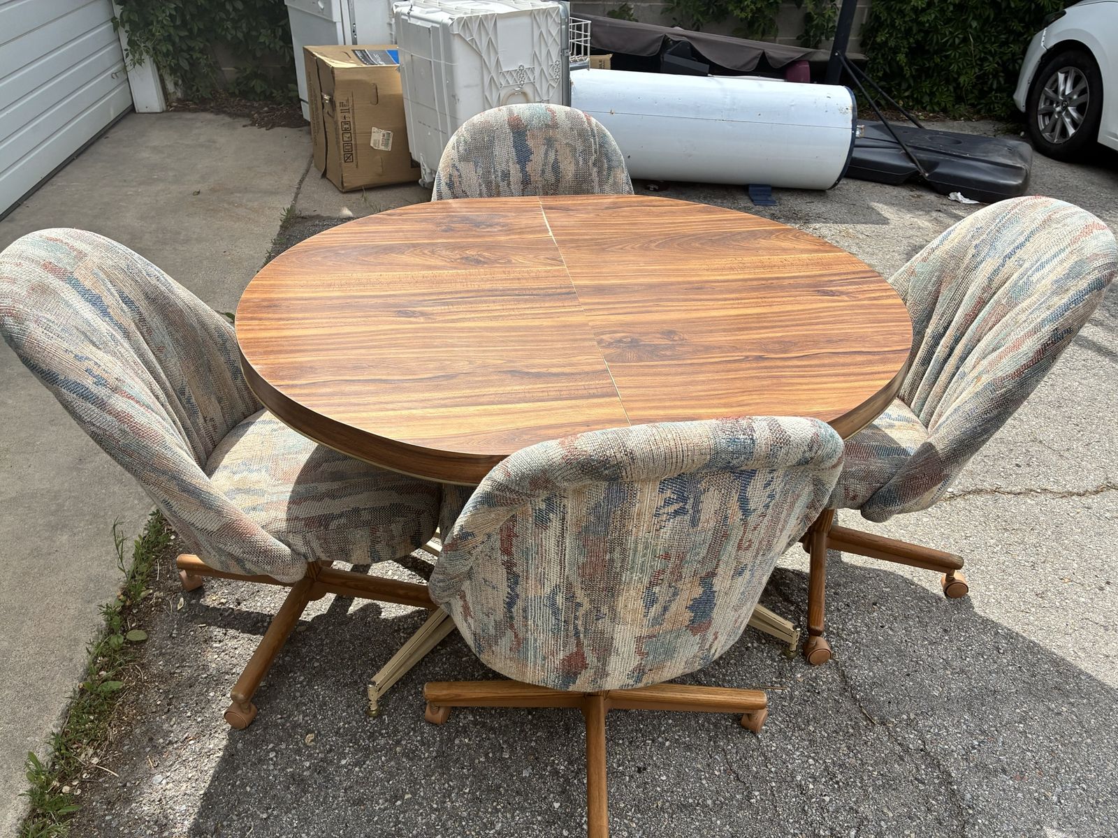 Vintage Wood Grain Dining Table with 4 Rolling Upholstered Chairs and Leaf