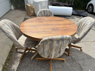 Vintage Wood Grain Dining Table with 4 Rolling Upholstered Chairs and Leaf