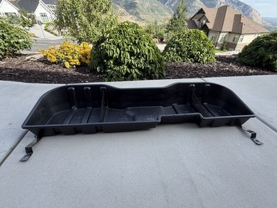 Black Plastic Under-Seat Storage Bin Organizer for a GMC Sierra 3500.