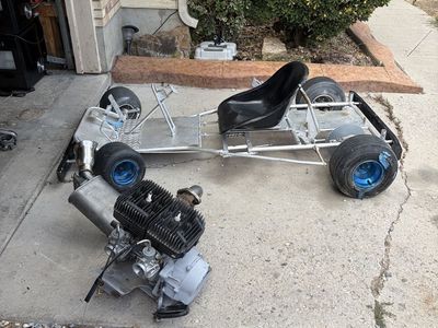 Go kart frame and Used Small Engine with Carburetor and Exhaust System. Looking for mini bike trade