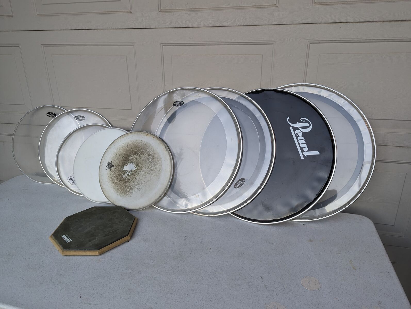 Assorted drumskin heads and two practice drums