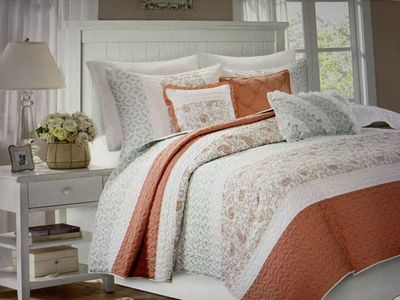 Queen percale quilt, shams, and decorative pillows. Color peach, cream, with a soft light green in print.