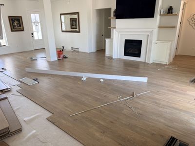 Used like new Laminate Flooring Planks -1000-1200 sq ft, Light Wood Grain, white baseboards