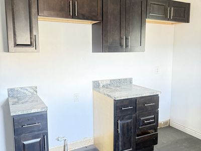 Free cabinets, countertops, desks & fridge.