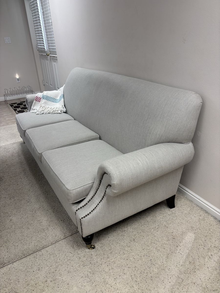 Light Gray Fabric Sofa with Rolled Arms and Nailhead Trim