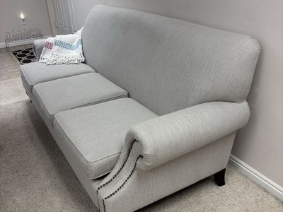 Light Gray Fabric Sofa with Rolled Arms and Nailhead Trim