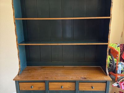 Storage cabinet with 2 drawers, and shelves.