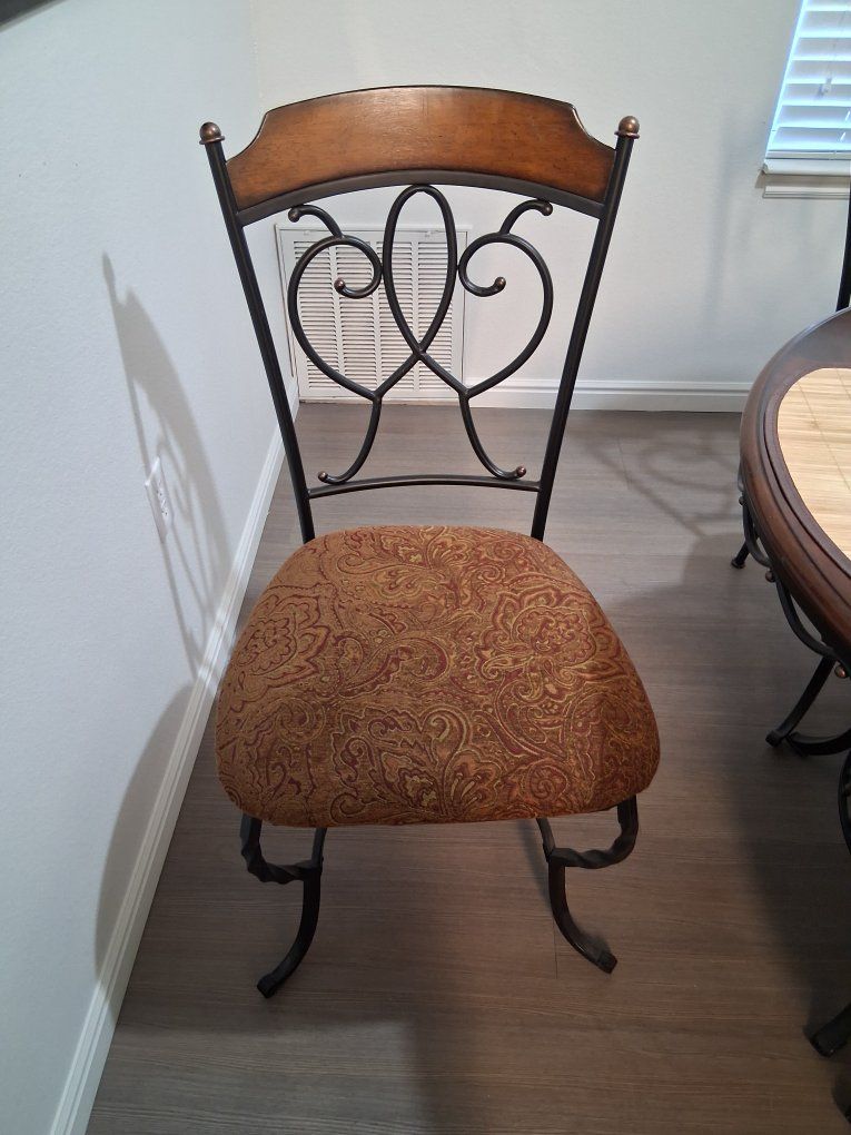 Round Dining Table with 4 Iron  Chairs and covers with center decoration included.