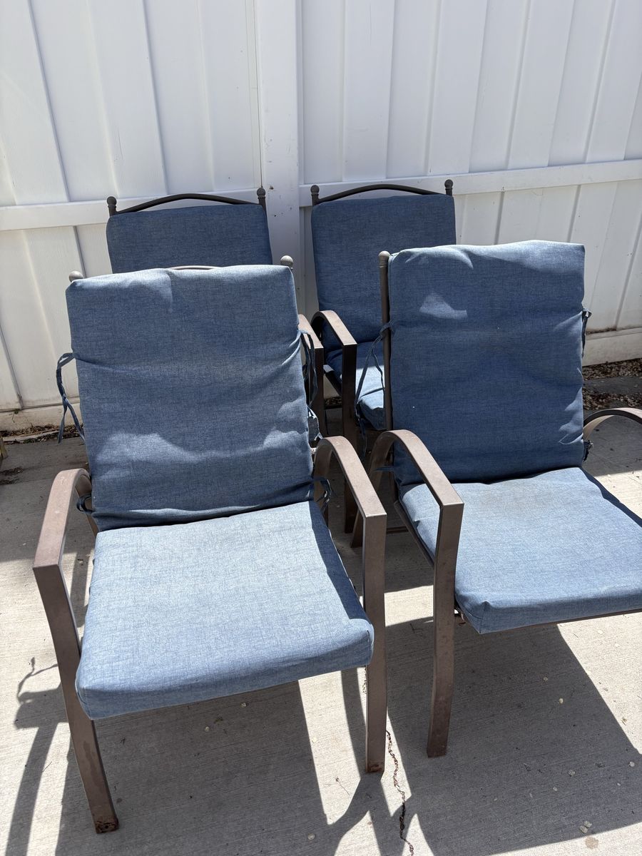 Set of 4 patio chairs with cushions.