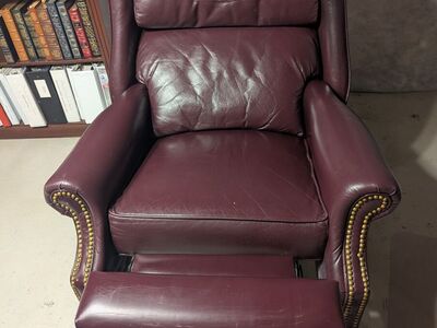 Burgundy colored reclining leather chair