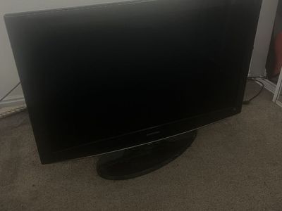 large Samsung tv with remote and power cord
